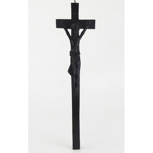 197 - A carved hardwood crucifix, with integral carved figure of Christ, 34cm high.