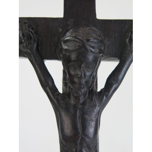 197 - A carved hardwood crucifix, with integral carved figure of Christ, 34cm high.