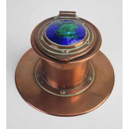 200 - Jesson Birkett & Co. An Arts & Craft copper inkwell, of cylindrical form, the hinged lid with green ... 