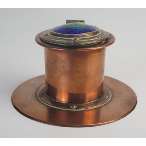 200 - Jesson Birkett & Co. An Arts & Craft copper inkwell, of cylindrical form, the hinged lid with green ... 