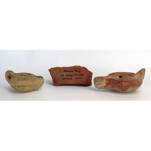 205 - A Roman terracotta oil lamp with a flattened base, smooth side walls, grooved perimeter, and a reces... 