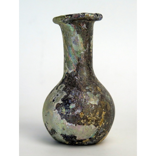 206 - A Roman glass cosmetic bottle, of ovoid form with flared long neck and folded rim, 8cm high 2nd - 3r... 