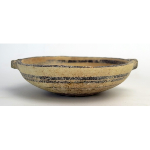 207 - A Cypro  archaic period kylex form bowl, probably Greek, with loop handles to the sides, plain bande... 