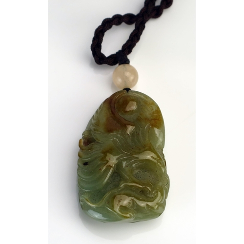 210 - A Chinese carved jade pendant, of oval form one side carved with a phoenix bird, the reverse decorat... 