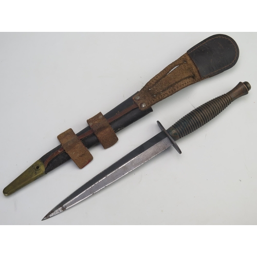 302 - A  Fairbairn Sykes third pattern fighting knife with 17.5cm double edged blade, with ribbed grip, co... 