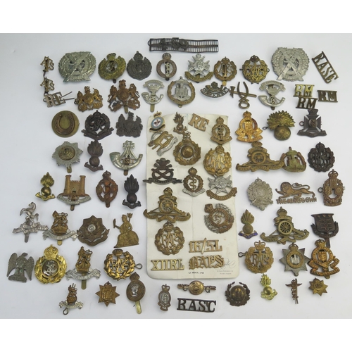 305 - An extensive collection of British regimental cap badges, RAF badges, shoulder badges etc.