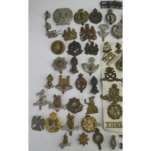 305 - An extensive collection of British regimental cap badges, RAF badges, shoulder badges etc.