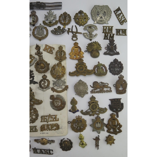 305 - An extensive collection of British regimental cap badges, RAF badges, shoulder badges etc.