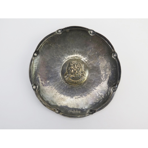 306 - A George V hammered silver regimental dish, maker Alwyn Carr, London, 1935, of circular form the cen... 