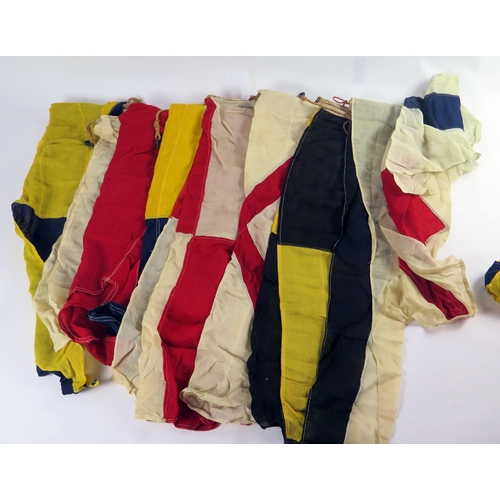 325 - A collection of nautical signalling pennants, contained in a canvas duffel bag.