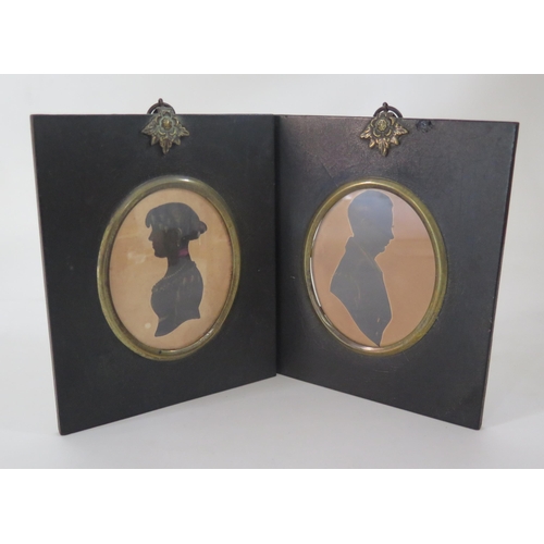 329 - A pair of Regency period silhouettes of a lady and gentleman, heightened in gilt and contained in eb... 