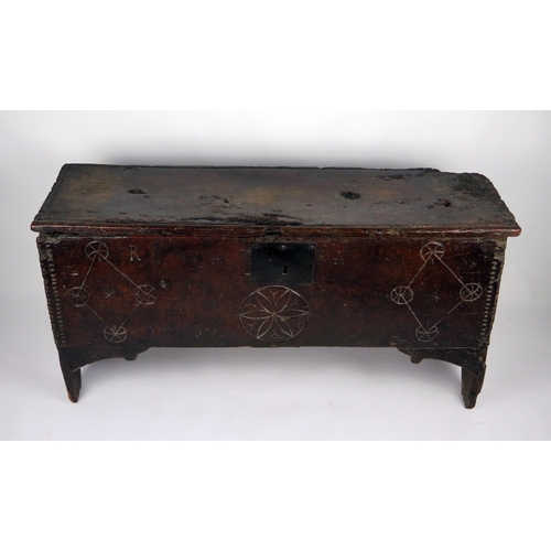 346 - A 17th century elm coffer, of rectangular outline, the hinged lid with moulded and chip carved edge,... 