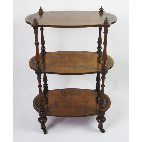 350 - A Victorian walnut and floral inlaid three-tier what not, of cartouche-shaped outline, on ring turne... 