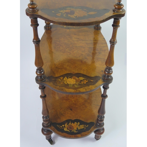 350 - A Victorian walnut and floral inlaid three-tier what not, of cartouche-shaped outline, on ring turne... 