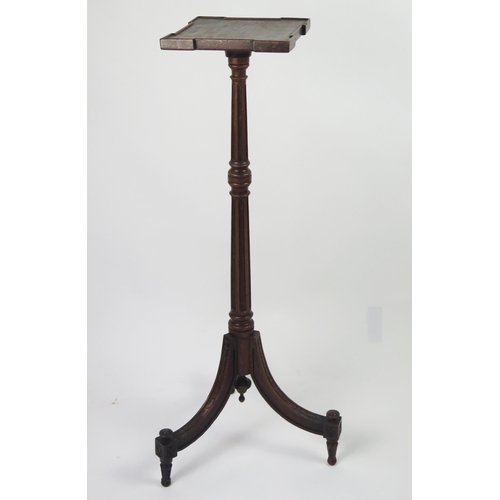 351 - An Edwardian mahogany torchiere stand with square top raised on a fluted and knopped column and swep... 