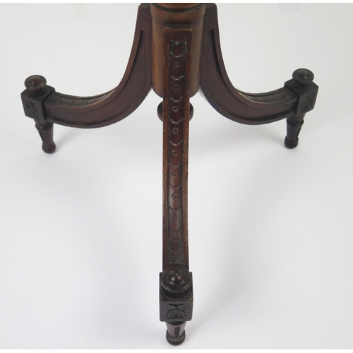 351 - An Edwardian mahogany torchiere stand with square top raised on a fluted and knopped column and swep... 