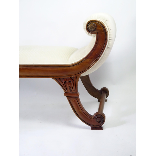 360 - A reproduction carved hardwood window seat in the regency taste, with padded scroll ends and padded ... 