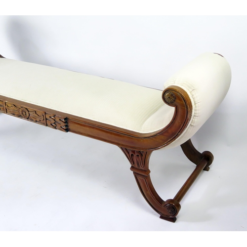 360 - A reproduction carved hardwood window seat in the regency taste, with padded scroll ends and padded ... 