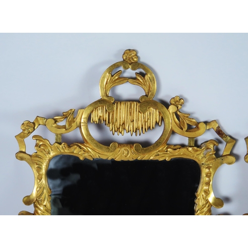 362 - A pair of late 18th century gilt wood wall mirrors of arched outline, with arched stalactite decorat... 