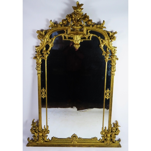 366 - A Louis XV style gilt wood pier glass of arched outline surmounted by a vase for flowers and foliage... 