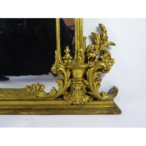 366 - A Louis XV style gilt wood pier glass of arched outline surmounted by a vase for flowers and foliage... 