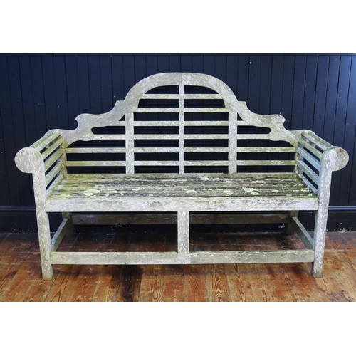 368 - A Lutyens style teak garden seat, with arched rail back, scroll ends, and railed seat, 165cm wide, 5... 