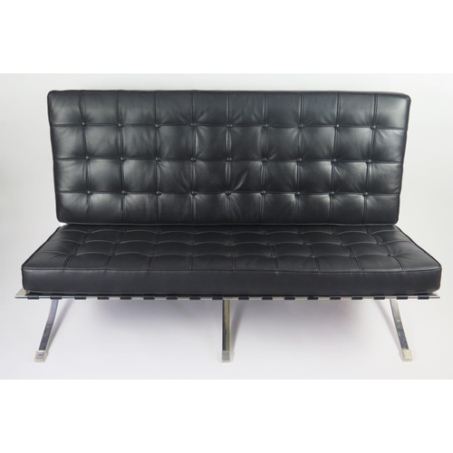 370 - A black Barcelona style sofa, with button down loose cushions, on a chrome X-frame with swept legs, ... 