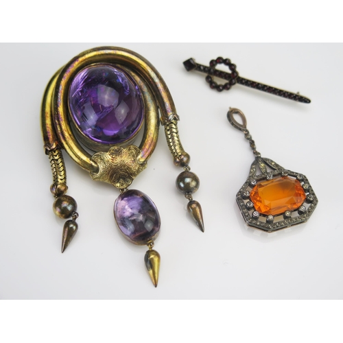 51 - A Victorian Pinchbeck and Foil Backed Cabochon Amethyst Locket Back Brooch, 76.6mm drop, 19th centur... 