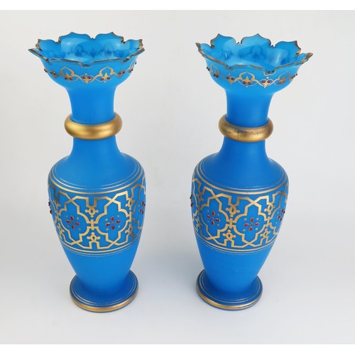 168 - A pair of 19th century blue glass vases with flared rims, ring necks and ovoid bodies, on a circular... 