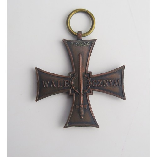 308A - A Polish Cross of Valour medal, impressed no. 50464, lacks ribbon.