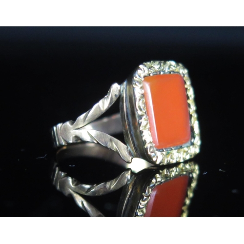 102 - A Georgian Carnelian Ring in a precious yellow metal and plated setting,  15mm head, size K, 3.37g