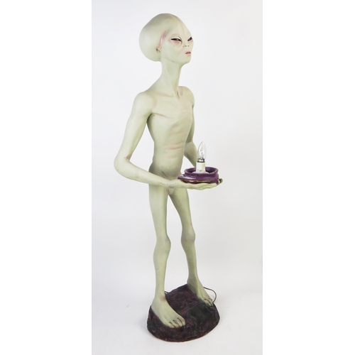 1033 - Life Size Alien Resin Figure holding a lamp (wired and working) standing on a purple rock base, 49.5... 