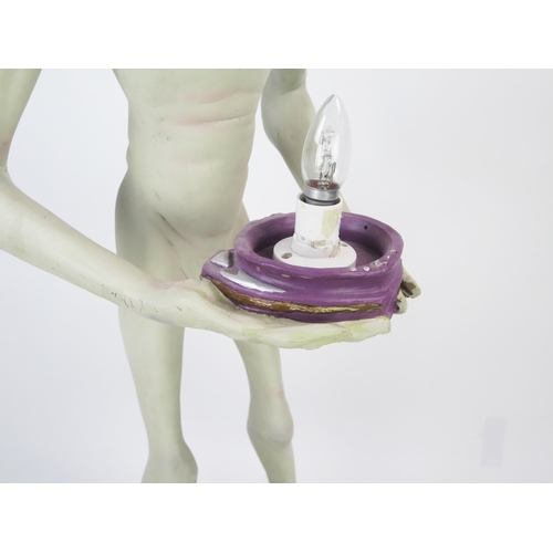 1033 - Life Size Alien Resin Figure holding a lamp (wired and working) standing on a purple rock base, 49.5... 