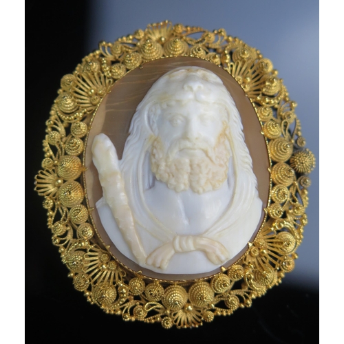 105 - A Shell Cameo Brooch in a precious yellow metal filigree setting, decorated with the bust of Hercule... 