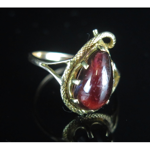 107 - An Antique 9ct Gold Snake Ring mounted with a cabochon garnet, 19.7x12.3mm head, size R.25, stamped ... 