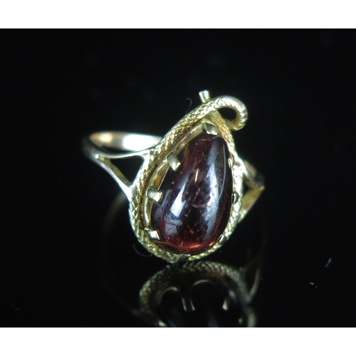 107 - An Antique 9ct Gold Snake Ring mounted with a cabochon garnet, 19.7x12.3mm head, size R.25, stamped ... 