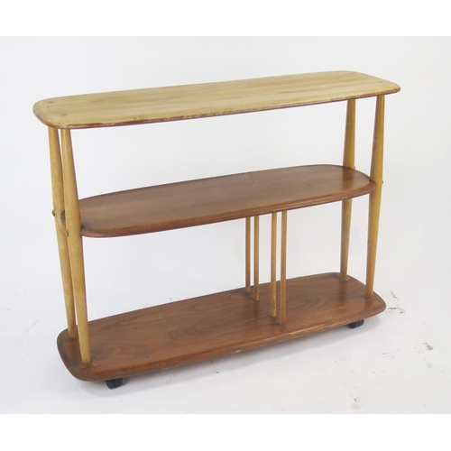 1140 - An Ercol Baby Giraffe Elm Three Tier What Not on castors, 91(w)x32(d)x67(h)cm