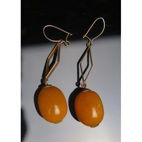 126 - A Pair of Amber Bead Earrings in precious metal settings, c. 16x13mm beads, 41mm drop to clasp, 5.04... 