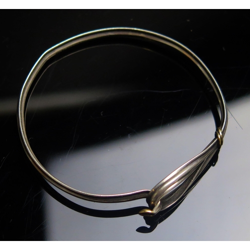 143 - A Tiffany & Co. Silver and 18ct Gold Bangle, stamped marks, 11.96g