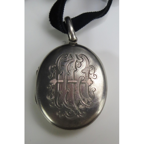 146 - A Victorian Precious White Metal Locket with satin finish and monogram, tests as silver, 61mm drop