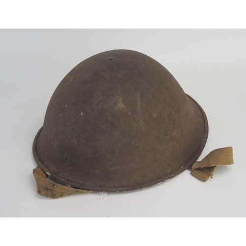 1552 - A British Mk III steel turtle helmet, with leather liner and canvas chin strap.