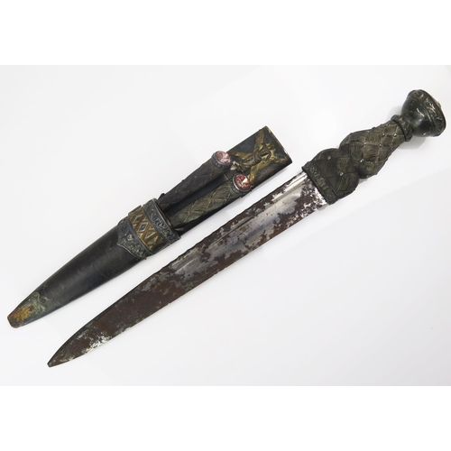 1568 - A regimental dirk, with 29.5cm fullered blade, with ebonised basket weave hilt with cairngorm pommel... 