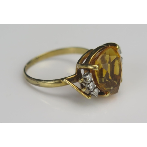 177 - A Citrine and Diamond Dress Ring in a precious yellow metal setting, 12.1x11mm principal stone with ... 