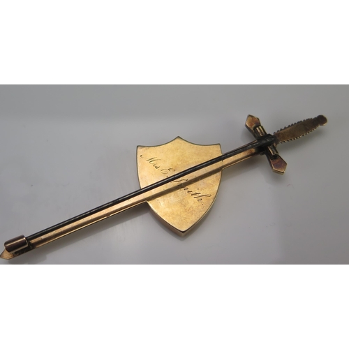 197 - A Goldstone Shield and Sword Precious Yellow Metal Brooch, 85.5mm long, KEE tests as 15ct, 11.68g.  ... 