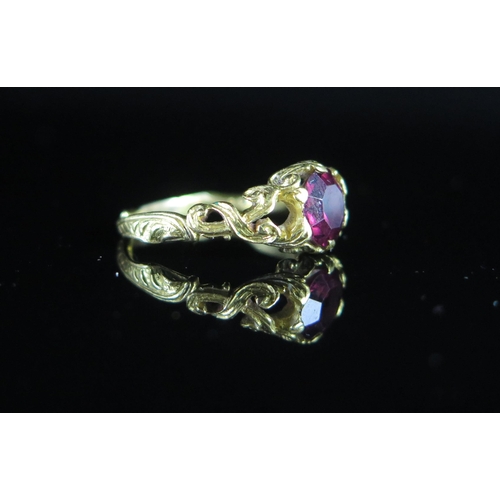 231 - A Georgian 'Ruby' Paste Ring in a precious yellow metal setting with pierced and chased shank, c. 7m... 