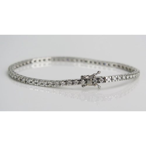 30 - An 18ct White Gold and Diamond Tennis Bracelet in an Ernest Jones box, set with c. 1.9mm stones, 7.5... 