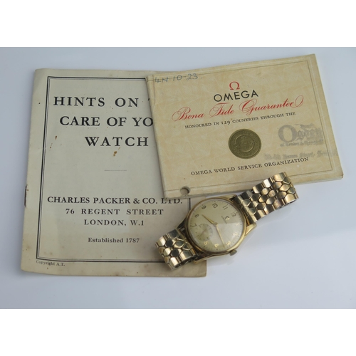 423 - An OMEGA Gent's 9ct Gold Cased Manual Wind Wristwatch, 33.7mm case, sold with booklets Winds & runs