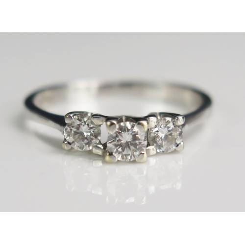 47 - A Modern 18ct White Gold and Diamond Three Stone Ring, 3.6mm principal stone, 3.37mm shoulder stones... 