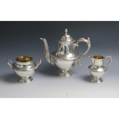 516 - An Edward VII silver three-piece tea service, maker Walker & Hall, Chester, 1906, of baluster form w... 