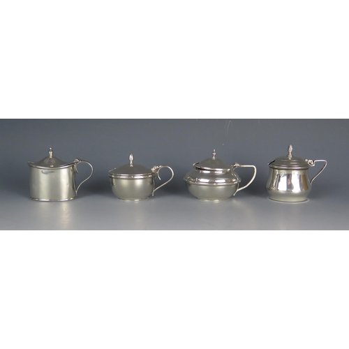 533 - Four assorted silver mustard pots and covers, various makers and dates, three with blue glass liners... 